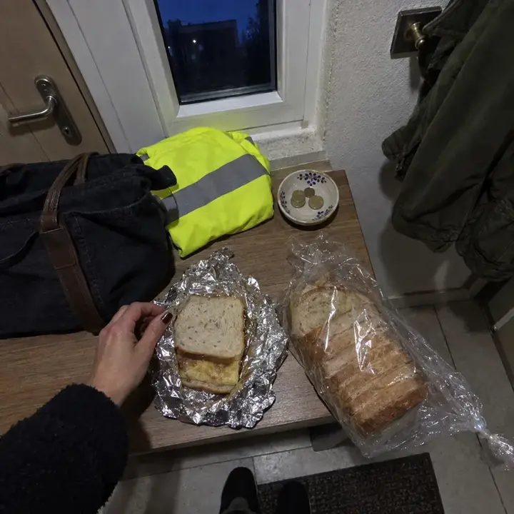 Bocadillo de tortilla con pan de molde casero sin gluten, medio envuelto en papel de aluminio junto a las llaves